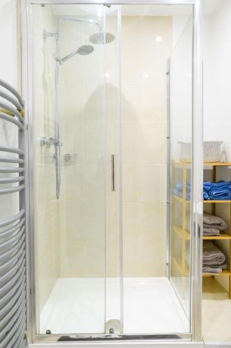 a shower with a glass door in a bathroom at Cathedral view in Lichfield