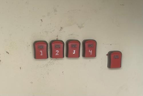 three red clocks hanging on a wall at 5 Brunswick St - Bedroom 02 downstairs in Bristol