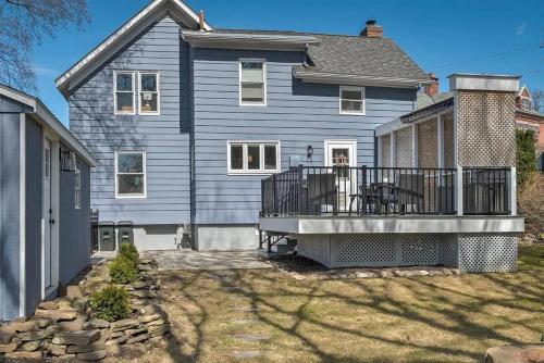 a large blue house with a large deck at The Leverett House in Keene