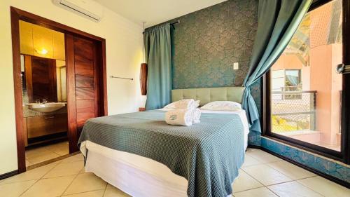 a bedroom with a bed with a sink and a window at Dream Beach Cumbuco Oceanfront Apartments in Cumbuco