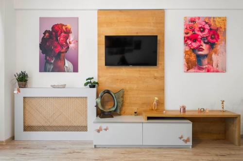 a living room with a tv on a wall at Moonlight Flower in Mamaia