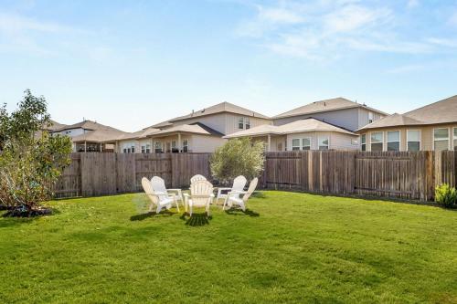 a yard with chairs and a fence and houses at Modern Austin Escape with Pool and BBQ in Austin