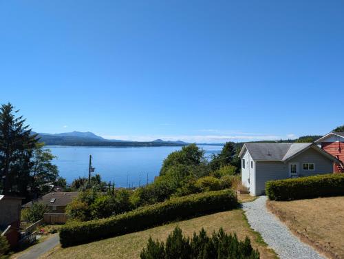 a view of a lake from a house at Alert Bay, Spacious Executive Suite with Panoramic Ocean Views in Alert Bay