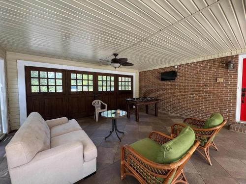 a living room with a couch and a table at Sunlit Hideaway 3BR 2BA house pool in Little River