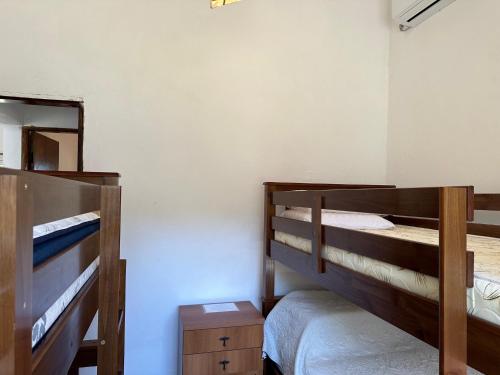 a bedroom with two bunk beds and a mirror at Hermosa con vista al mar in Cuchilla Alta