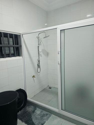 a shower with a glass door in a bathroom at Idg-Residence in Cotonou