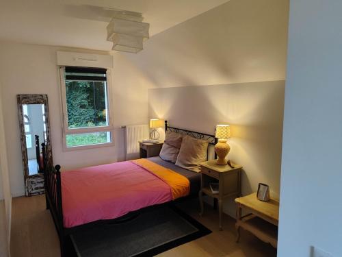 une chambre avec un lit et deux tables et une fenêtre dans l'établissement Maison St Valéry, à Saint-Valery-sur-Somme