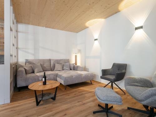 a living room with a couch and a table and chairs at Hopfgarten Alpin Living Top 3 und 4 in Hopfgarten im Brixental