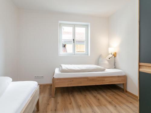 a bedroom with a bed and a window at Hopfgarten Alpin Living Top 3 und 4 in Hopfgarten im Brixental