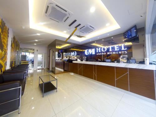 a lobby of a hotel with a bar and televisions at GM Grand Moments Bandar Sunway in Petaling Jaya