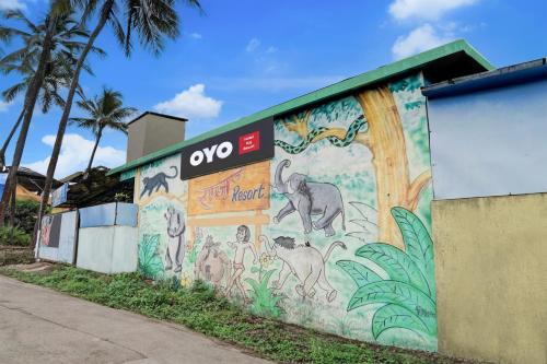 a building with a mural on the side of it at Hotel O Raj Resort in Sopāra