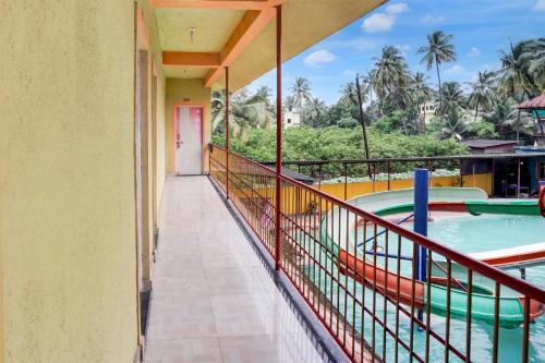 a balcony with a view of a swimming pool at Hotel O Raj Resort in Sopāra