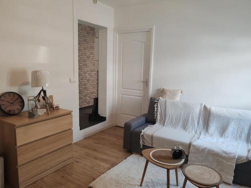 a living room with a couch and a table at Entire apartment with outdoor area in Le Havre