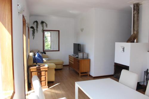 a living room with a couch and a refrigerator at Oporto- Lousada- Casa da Prêsa in Lousada