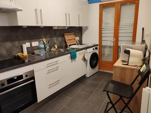 a kitchen with a sink and a stove top oven at Entire apartment with outdoor area in Le Havre