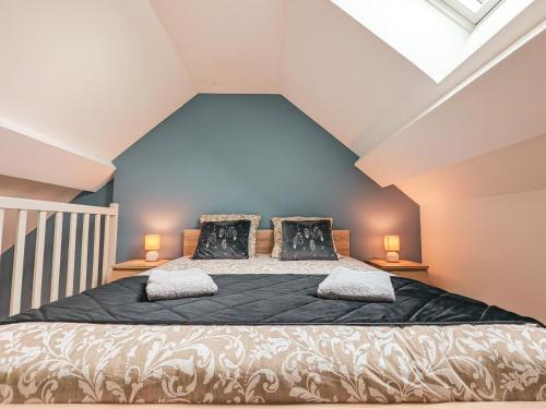 a bedroom with a large bed in a attic at Maison isolée avec jardin, piscine intérieure chauffée et équipements pour des vacances de rêve. - FR-1-591-330 in Orsennes