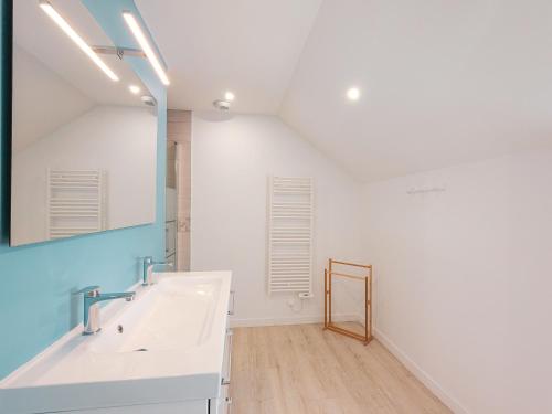 a bathroom with a sink and a mirror at Maison isolée avec jardin, piscine intérieure chauffée et équipements pour des vacances de rêve. - FR-1-591-330 in Orsennes