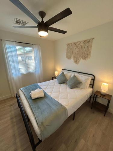 a bedroom with a bed with a ceiling fan at Sunfit Dreams 2BD BBQ Pool & Fitness in Mesa