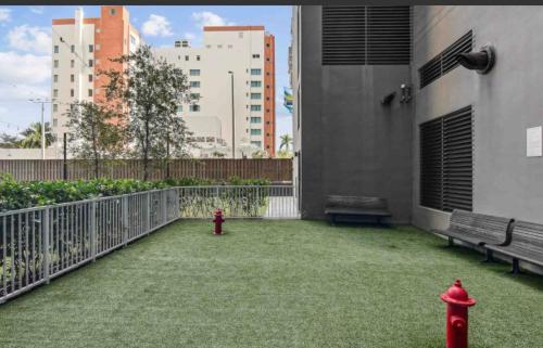 a red fire hydrant on a balcony with buildings at Downtown Miami Luxury Condo apartment in Miami