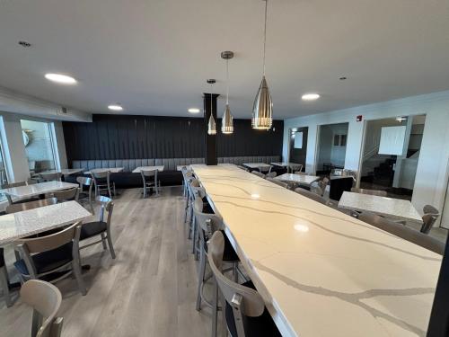 a dining room with a long table and chairs at Ramada by Wyndham Springfield North in Springfield