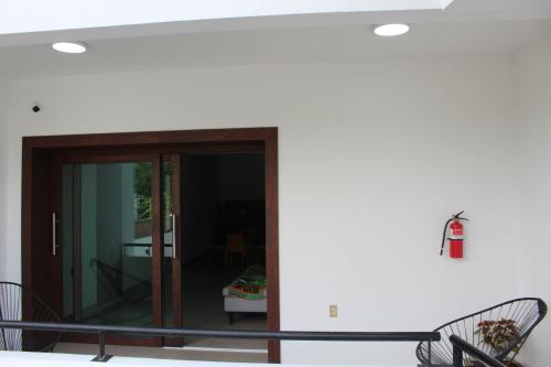 a room with a balcony with a glass door at Hotel Monkey House Tuxtla Gutiérrez in Tuxtla Gutiérrez