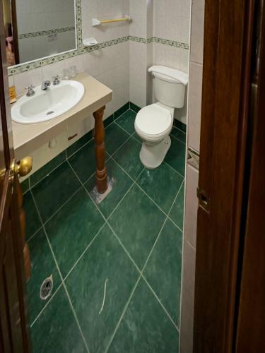 a bathroom with a toilet and a sink at Santuario Machupicchu in Machu Picchu