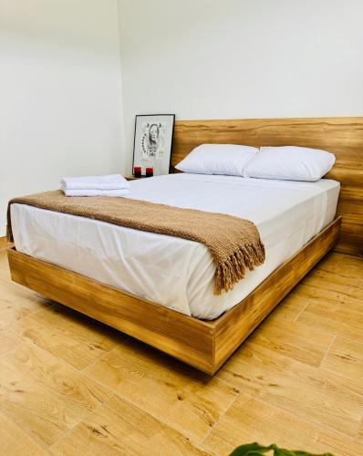 a bed with a wooden frame in a room at Quinta Piedad Suites in Guayaquil