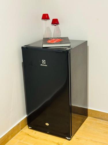 a black refrigerator with two lamps on top of it at Quinta Piedad Suites in Guayaquil