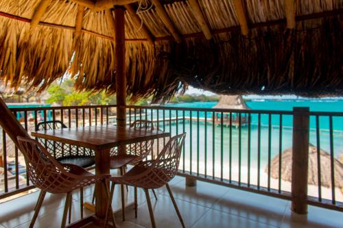 a table and chairs on the balcony of a resort at Hotel Isla del Sol in Isla Grande