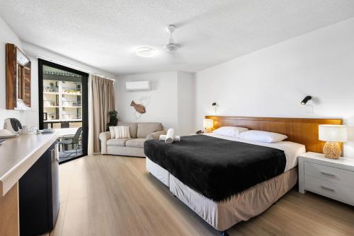 a bedroom with a bed and a living room at The Beach Retreat Coolum in Coolum Beach