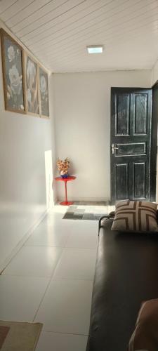 a living room with a couch and a black door at Apartamento familiar in Macapá