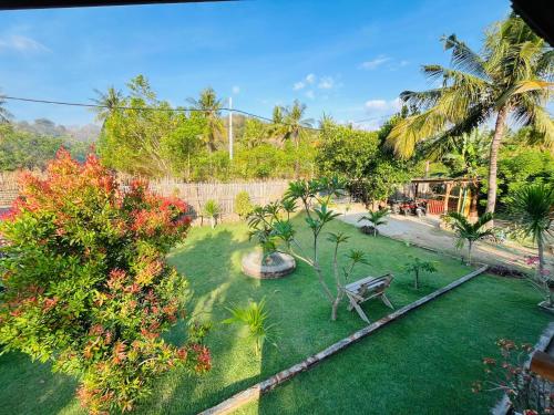a park with a bench in the middle of a yard at Medya homestay in Pulau Sarang