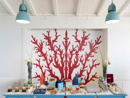 a table with a painting of a wall with an octopus at Sunbay Park Hotel in Civitavecchia