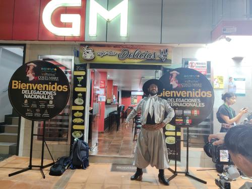 a man in a costume standing in front of a store at Hotel GM Three bed 39 Zamora in Zamora