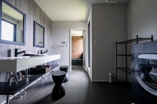 a bathroom with a sink and a toilet in it at SANA伊豆大室山 -Pool Villa- in Ito