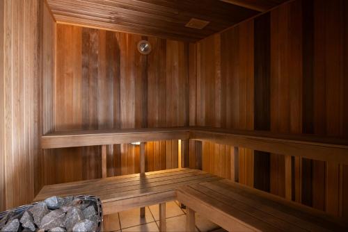 a sauna with wooden walls and a wooden bench at The Beach Retreat Coolum in Coolum Beach