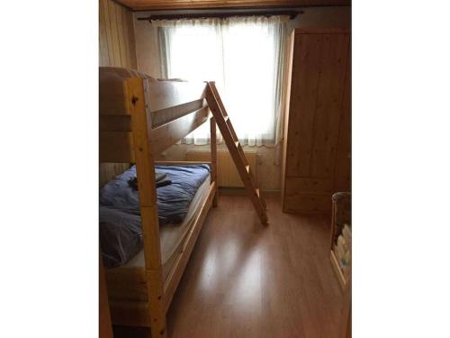 a room with two bunk beds and a window at Wooden holiday home with winter garden in Kleinweidelbach