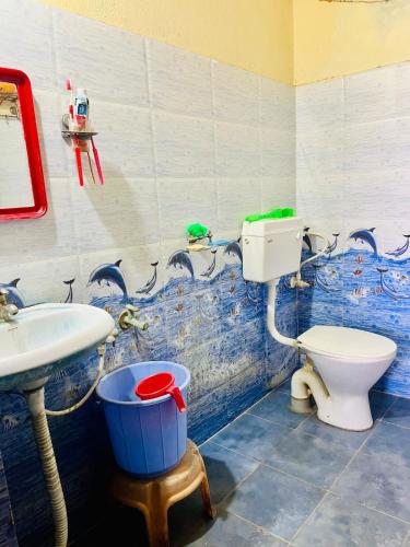 a bathroom with a toilet and a sink at Lakshmi Nilayam in Warangal