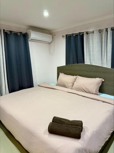 a bedroom with a large bed with a towel on it at RN Homestay Nadi Fiji in Nadi International Airport