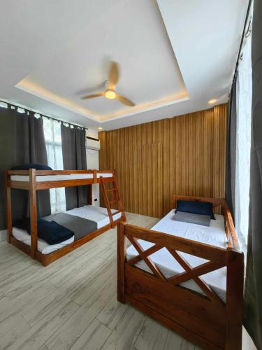 two bunk beds in a room with a ceiling at Aura Spring Resort in Los Baños