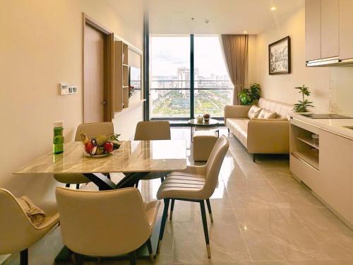 a kitchen and living room with a table and chairs at ICON40 Ha Long Luxury Apart in Ha Long