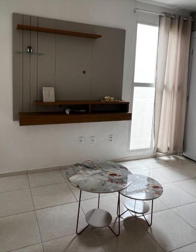 a living room with a table and a window at Conquista Salvador in Salvador