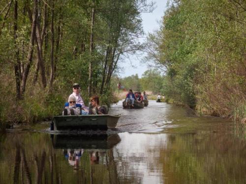 a group of people riding in a boat on a river at Lakeside Villa with Terrace in Delfstrahuizen