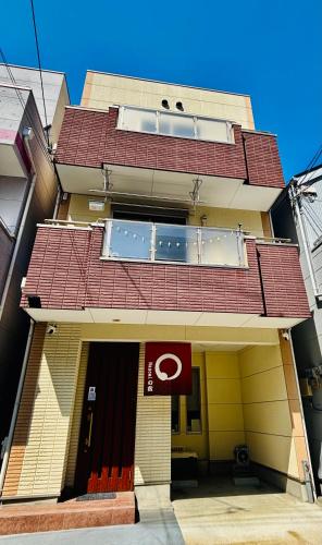 a building with a red roof on top of it at Nagomiの宿駅徒歩3分駐車場有梅田1駅1棟貸切4部屋京都神戸直通 in Osaka