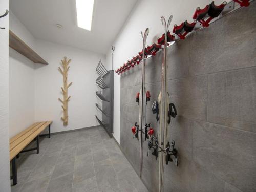 a room with a wall with a bunch of weapons at Nationalpark Chalet Dreiherrenspitze in Rosenthal
