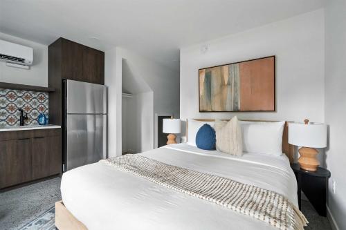 a bedroom with a large white bed and two lamps at Adelynn Studio Walkable Kerns Spanish Charm in Portland