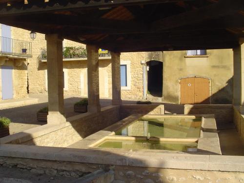 a building with a pool of water in a courtyard at La Maison St Gervais in Saint-Gervais
