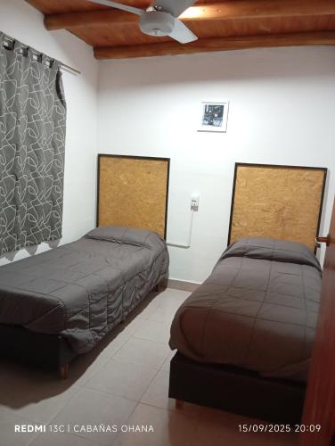 two beds sitting next to each other in a room at Ohana in Potrero de Garay