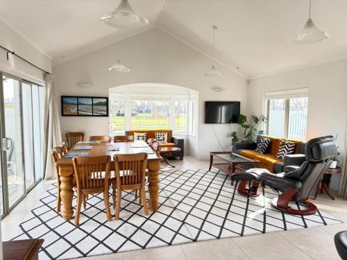 a living room with a table and chairs at The light Inn in Christchurch