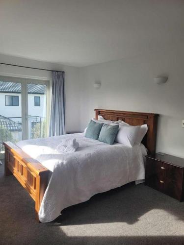 a bedroom with a large bed and a window at The light Inn in Christchurch